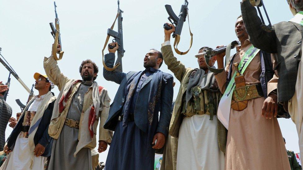 Mourners hold up their rifles as they attend a mass funeral in Saada, Yemen on 13 August 2018.