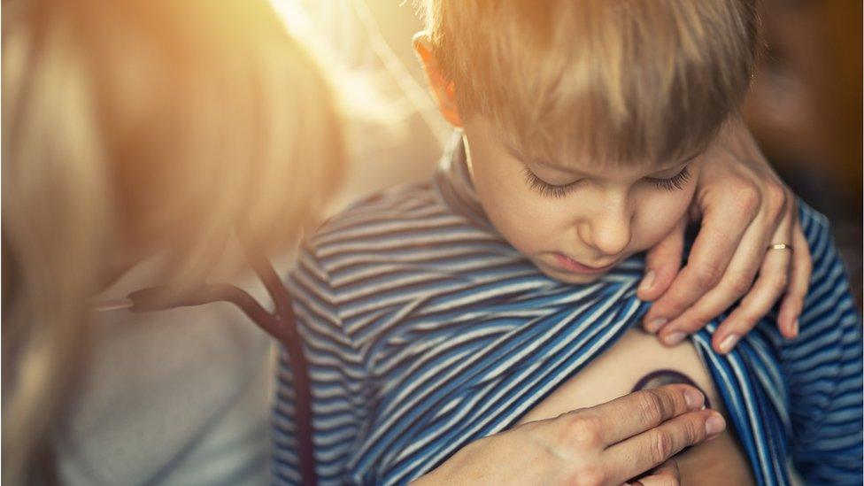 Little boy having his chest listened to