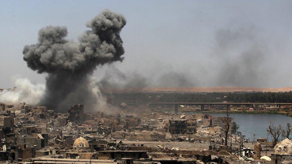 Smoke billowing following an airstrike by US-led international coalition forces targeting Islamic State (IS) group in Mosul on 9 July