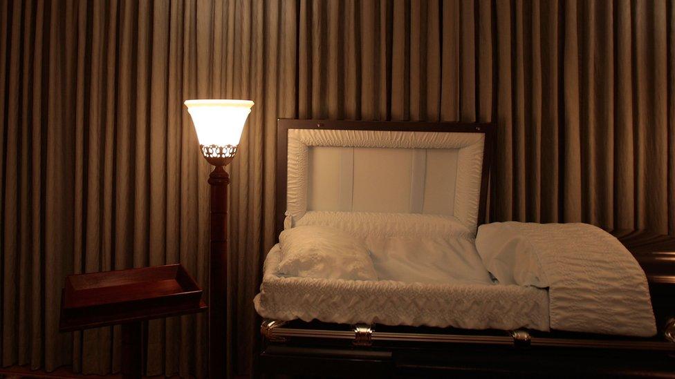 An empty coffin in a funeral home