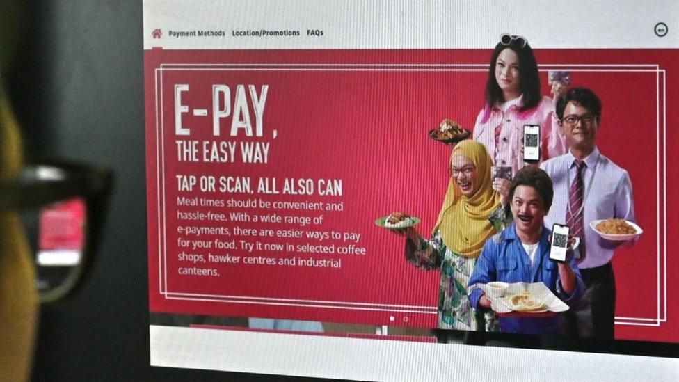 The Nets e-pay advert showing actor Dennis Chew in dark make up, dressed as both an Indian man and a Malaysian woman in a hijab