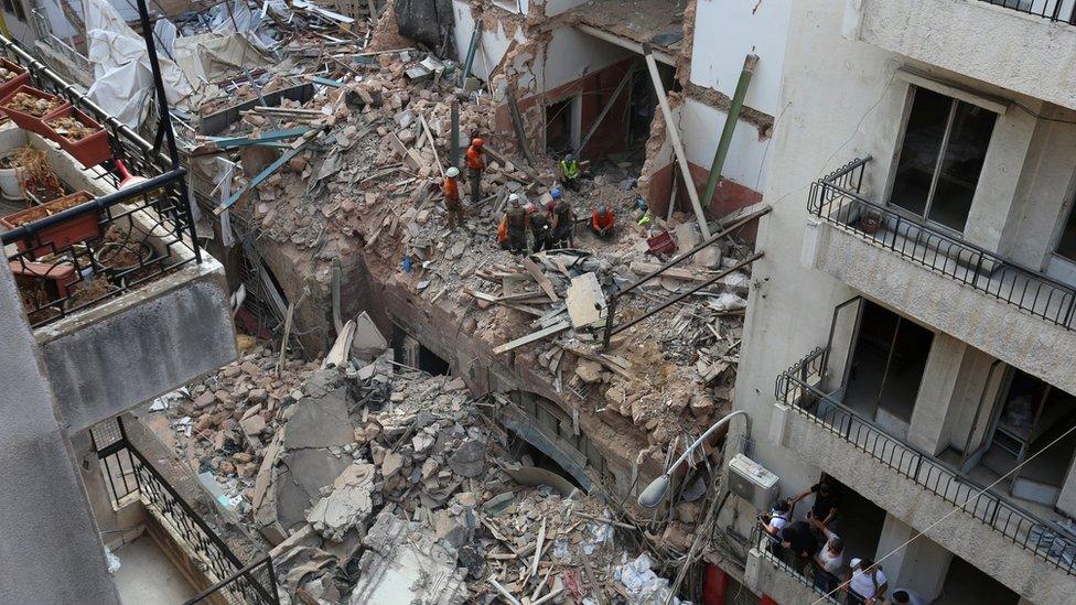 Rescue workers clear through rubble in Beirut