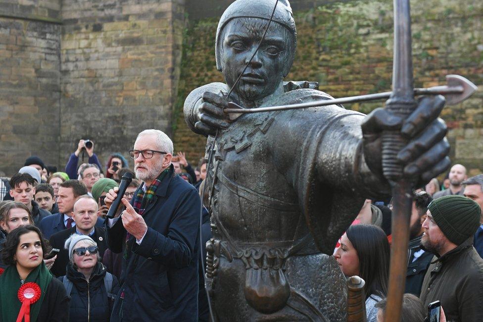 Jeremy Corbyn next to a statue of Robin Hood