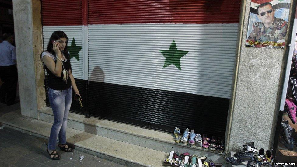 A Syrian woman speaks on her mobile phone