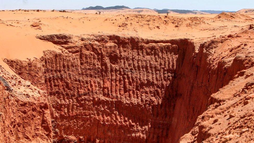 A vast trench dug by gold hunters is pictured at the devastated two millenia-old site of Jabal Maragha, in the desert of Bayouda