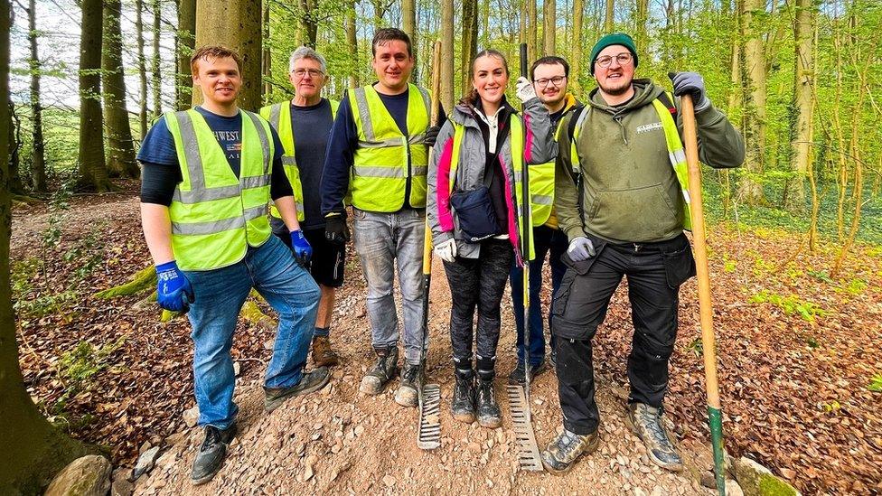 A group of Ride Bristol volunteers stand with their equipment in Ashton Court in Bristol