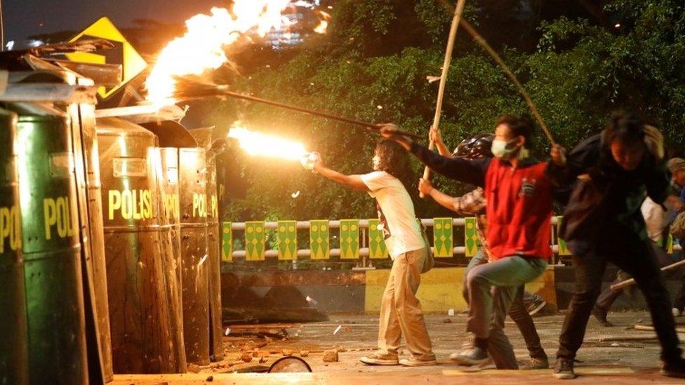 Protesters clash with police outside parliament in Jakarta