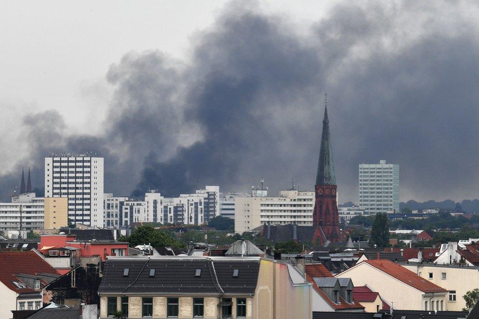 Smoke hangs over the Schanzenviertel district of Hamburg, 7 July