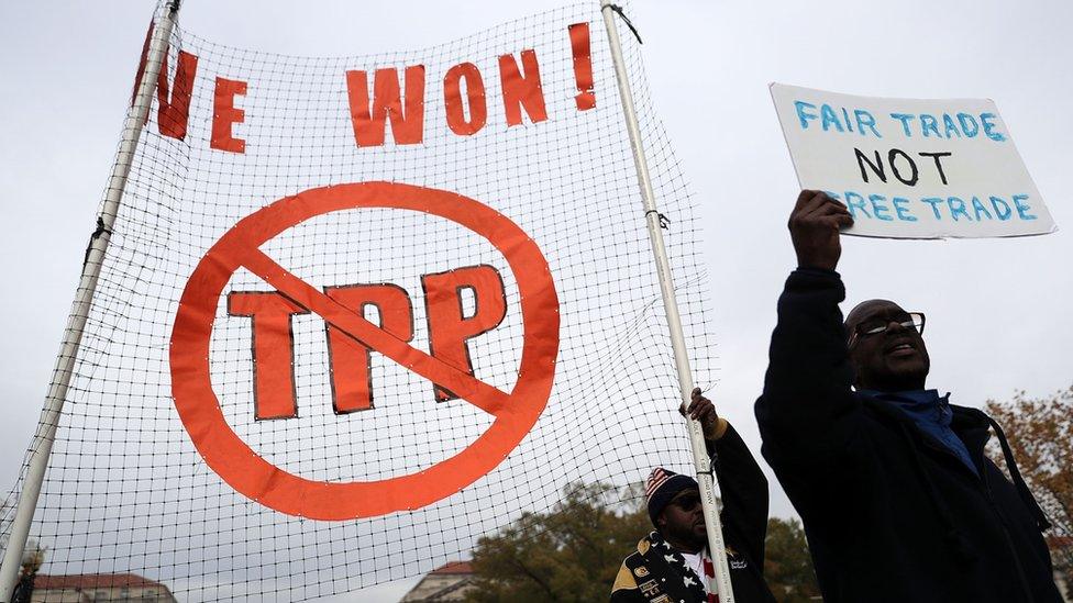 Activists shout slogans as they march during an anti-Trump and anti-TPP protest November 14, 2016 in Washington, DC. Activists held a rally and a march "to protest the Trans-Pacific Partnership and urge President-elect Donald Trump and members of Congress to reject the trade deal.