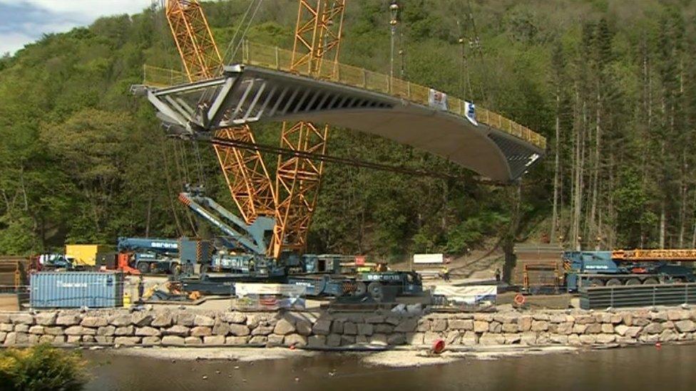 The bridge being lifted into place