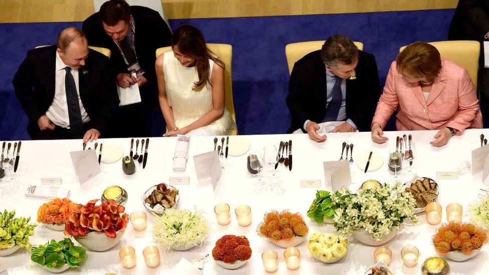 Russia's President Vladimir Putin, US First Lady Melania Trump, Argentina's President Mauricio Macri, German Chancellor Angela Merkel attend the banquet after a concert at the Elbphilharmonie concert hall during the G20 Summit in Hamburg, Germany, on July 7, 2017. Leaders of the world's top economies will gather from July 7 to 8, 2017 in Germany for likely the stormiest G20 summit in years, with disagreements ranging from wars to climate change and global trade