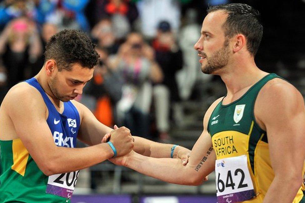 Brazilian Paralympian Oliveira is congratulated by Pistorius after the 200m race