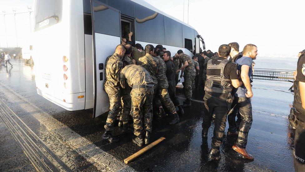 Soldiers getting onto a bus