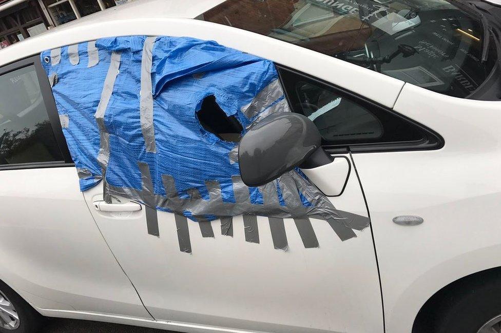 Car with makeshift window repair