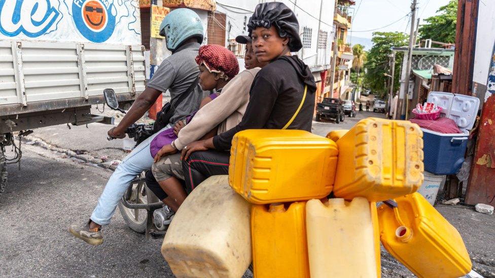 Gas dealers riding motorcycles in the street in Port-au-Prince