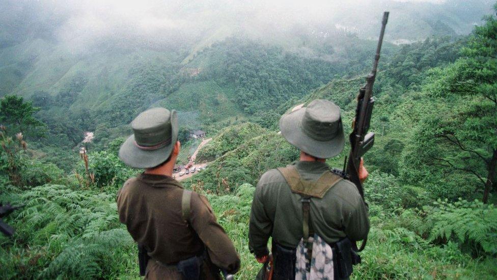 Undated picture of two armed Farc rebels monitoring the Berlin pass