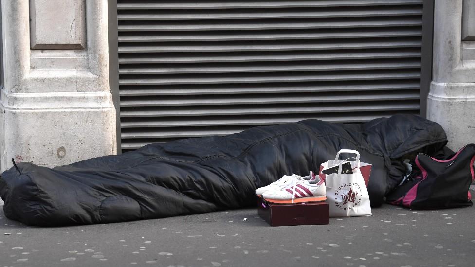 Person in sleeping bag on the street