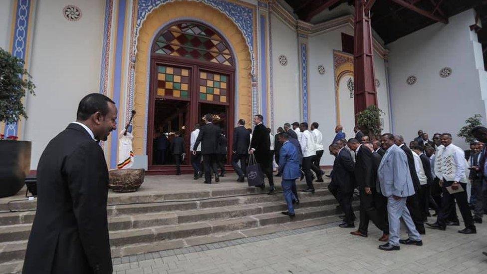 Ethiopian Prime Minister Abiy Ahmed looks on as guests arrive at the Menelik Palace in Addis Ababa