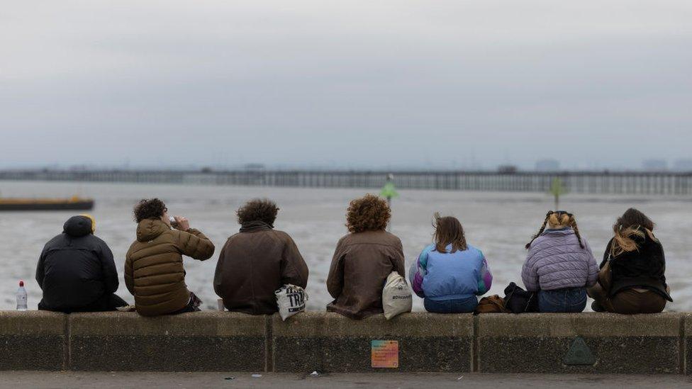 young people sat on a wall on Southend seafront