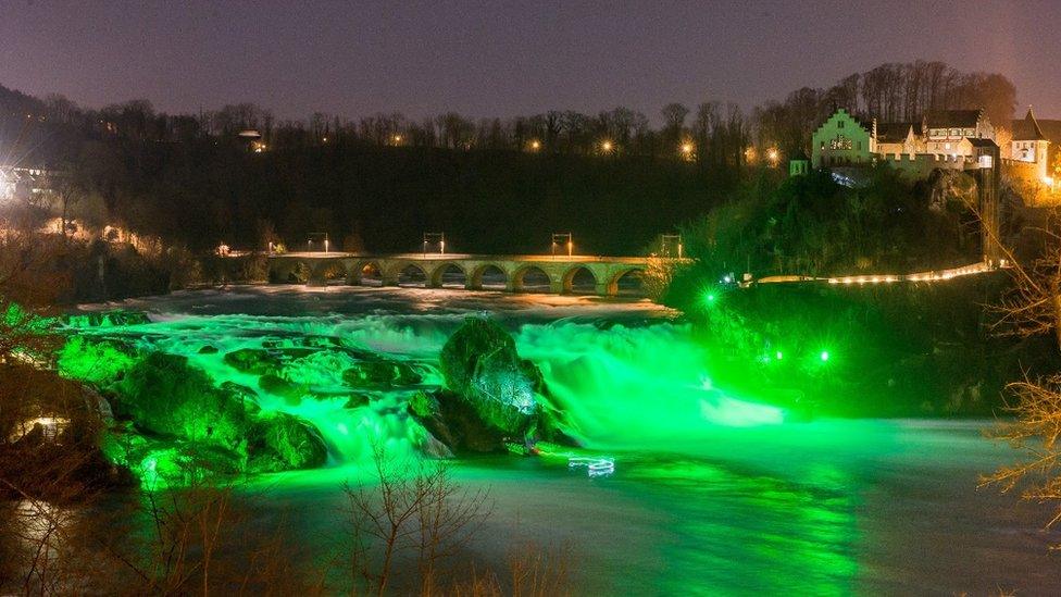 Rhine Falls, near Zurich, Switzerland, were bathed in green