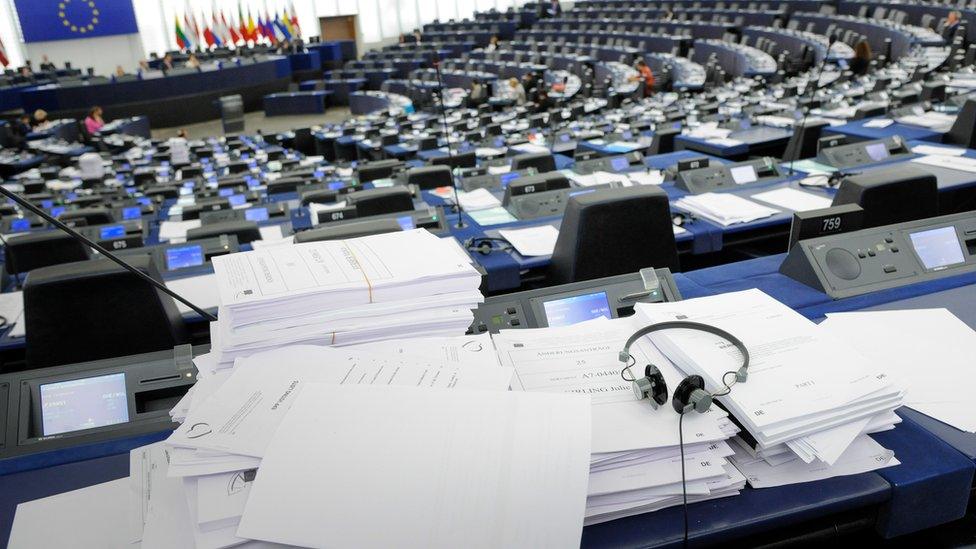 Documents on an MEP's desk in the Strasbourg chamber