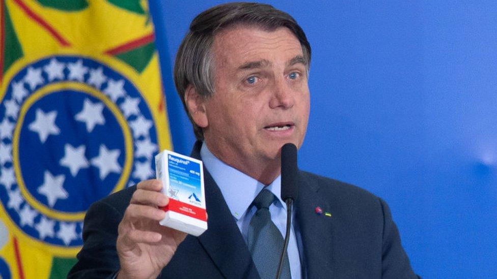 President of Brazil Jair Bolsonaro shows a box of chloroquine medicine on 16 September 2020