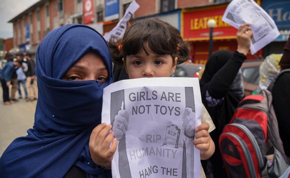 A young Kashmiri protester seen holding a placard during a protest in Srinagar.