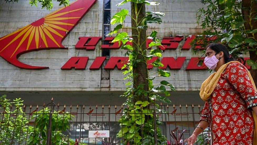 A pedestrian walks past the Air India building in Mumbai on October 1, 2021. (Photo by Punit PARANJPE / AFP)