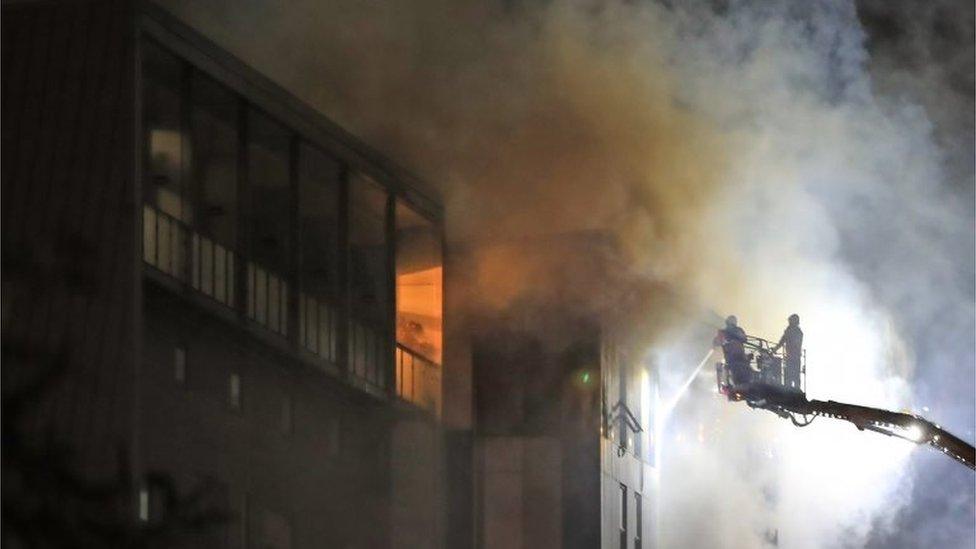 Fire fighters at the scene after a fire on the top floors of a building on Bradshawgate in Bolton.