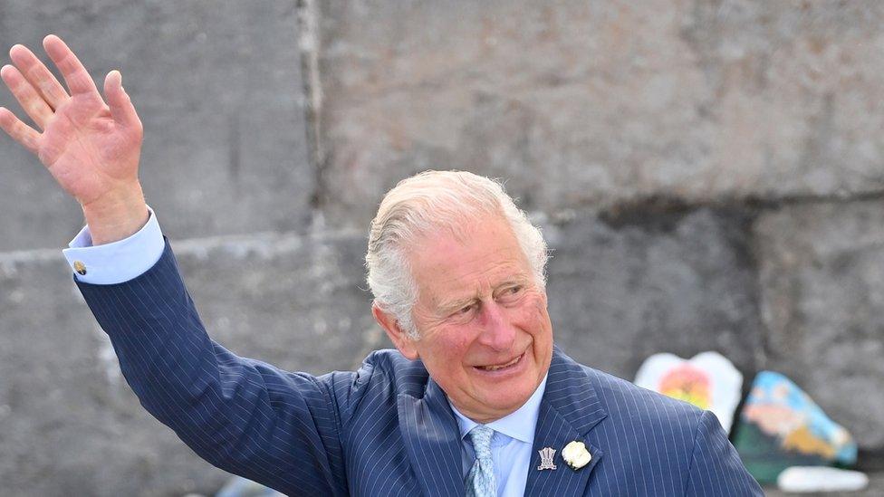 Prince of Wales arrives to view stones which line the Donaghadee Harbour walls and were decorated with messages of hope by local people during the pan