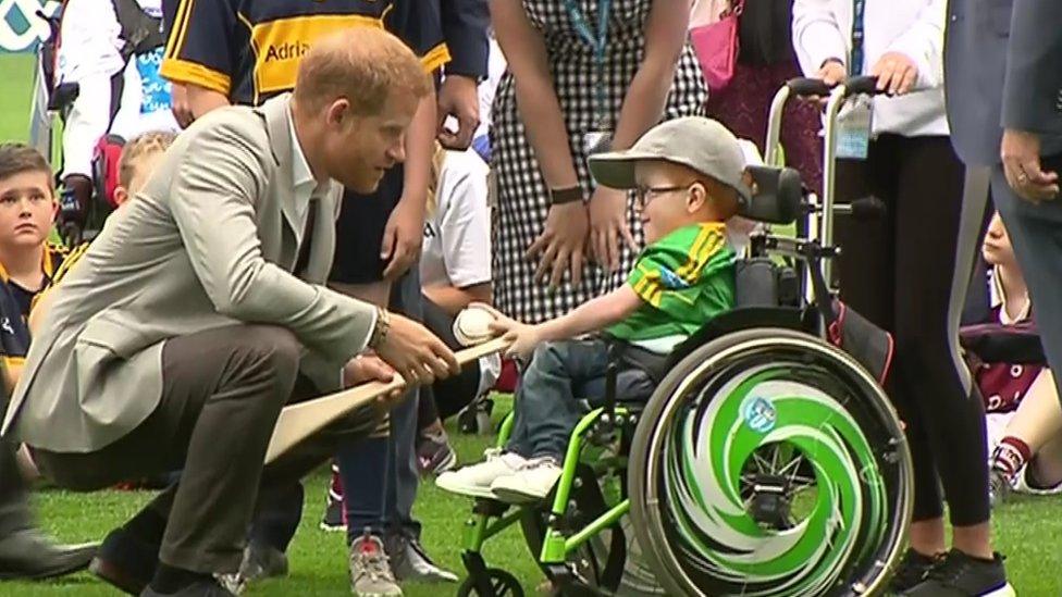 Prince Harry with a boy in a wheelchair