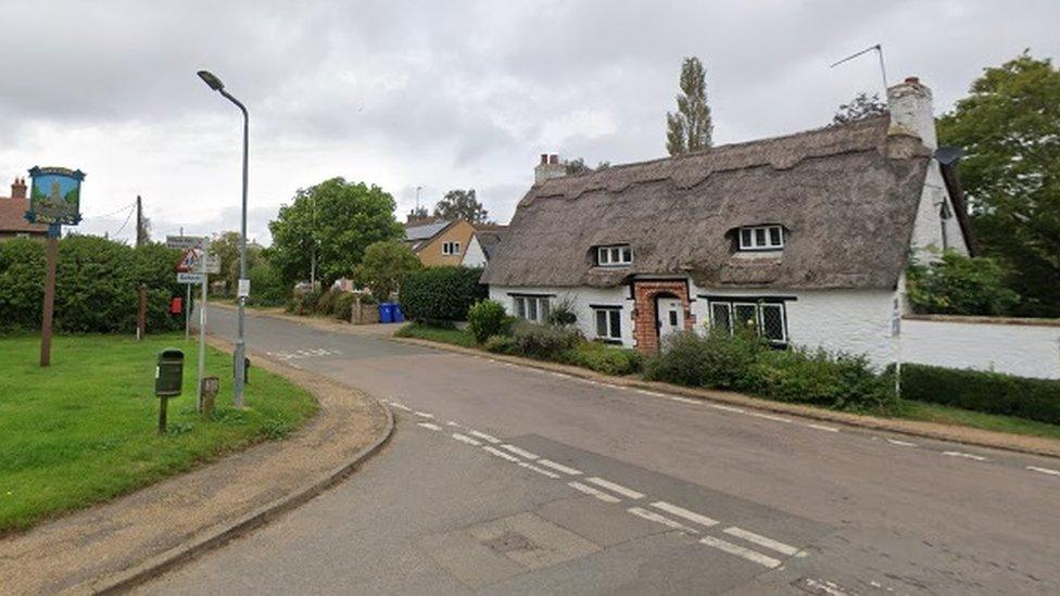 Village crossroads, showing Gayton sign and historic cottages