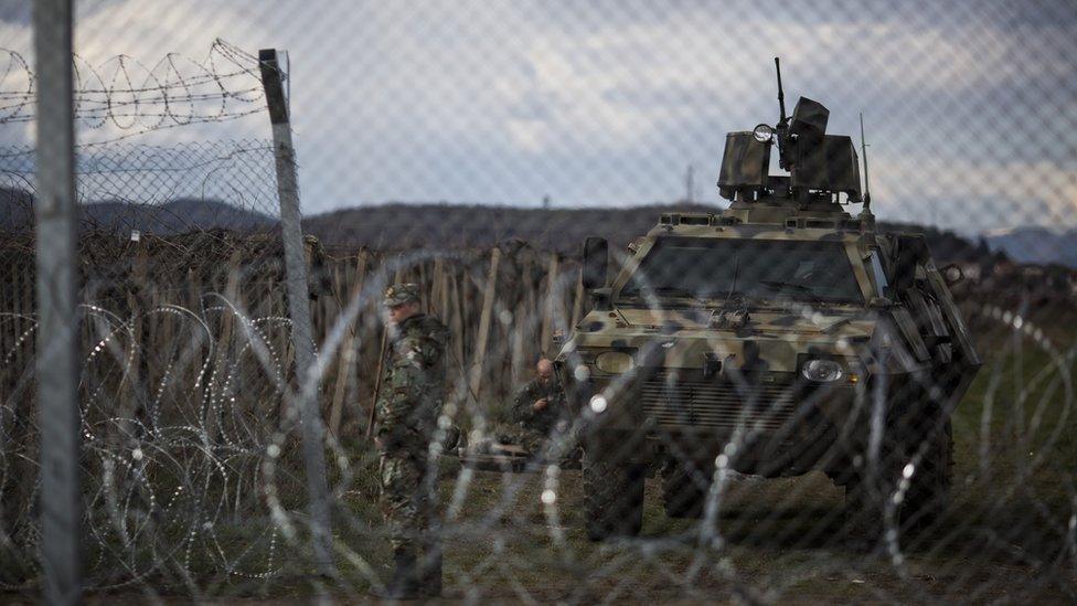 A Macedonian military vehicle sits behind the wire border fence that runs between Greece an Macedonia on March 04, 2016 in Idomeni, Greece