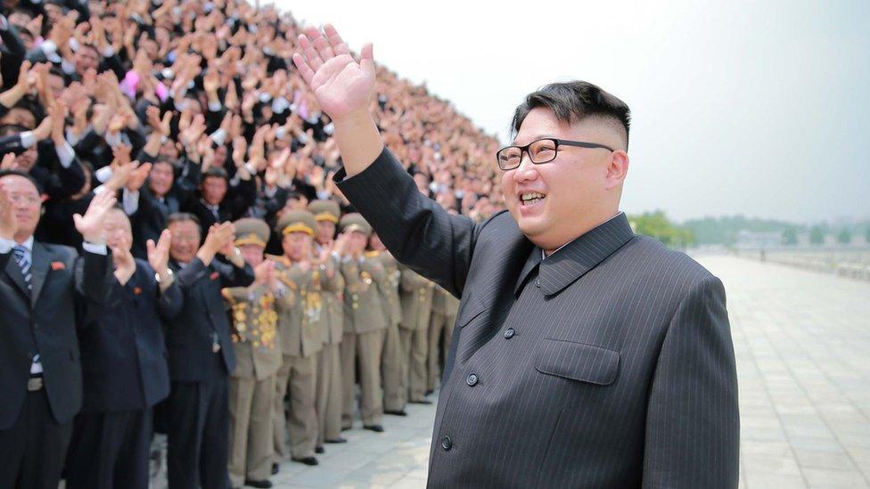 North Korean leader Kim Jong-un waves at a crowd