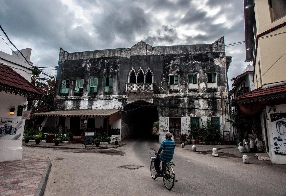 A man cycles in Zanzibar