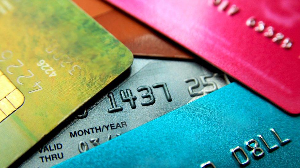 Stack of multicoloured credit cards.