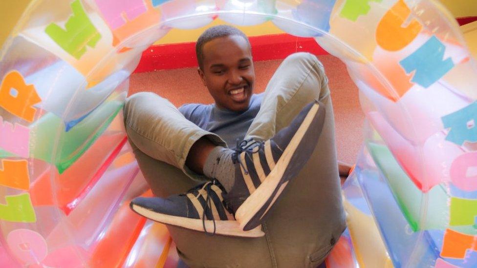 Young person playing inside an inflatable ring