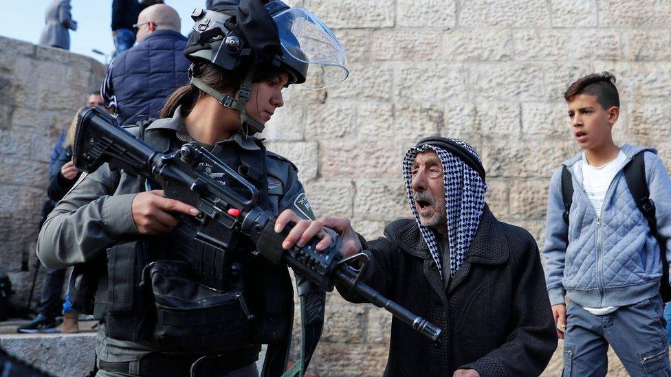 Palestinian man and Israeli soldier outside Damascus Gate in Jerusalem on 7 December 2017