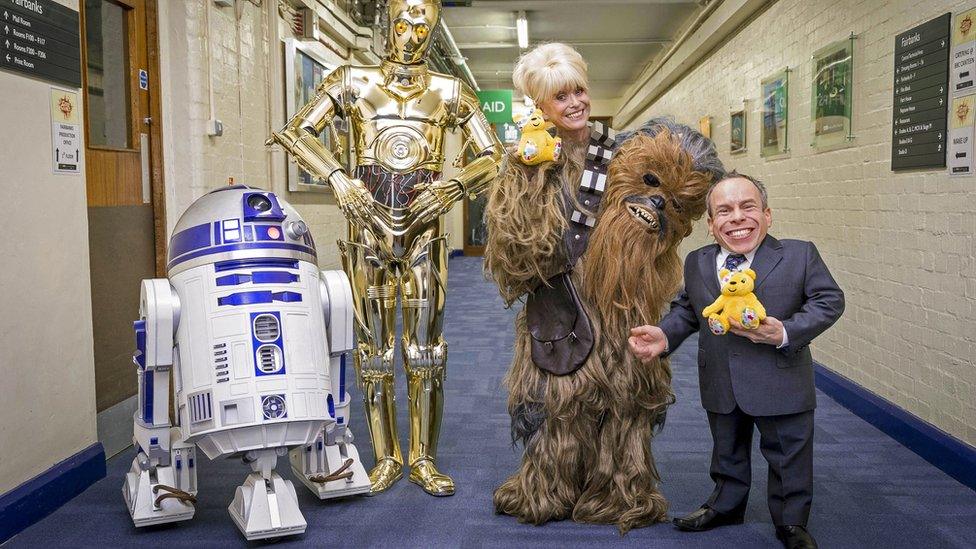 Barbara Windsor with actor Warwick Davis, C-3PO and R2-D2.