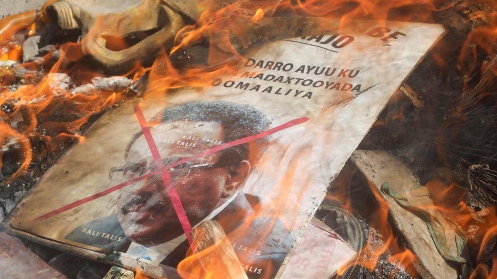 A placard with a picture of Somalia's president burns on a street of Mogadishu, Somalia 25 April 2021