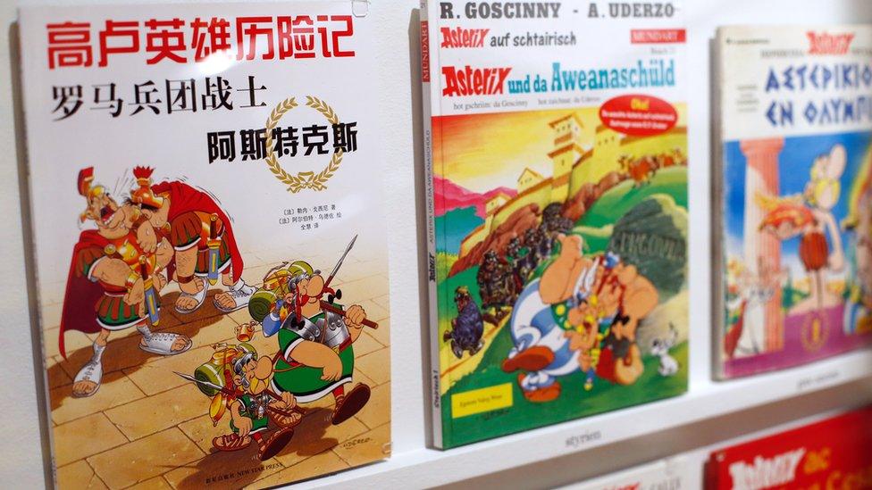 Asterix comics on a shelf in various languages