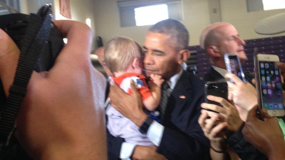 Obama, holding Brooks Breitwieser, 10 months, at a rally