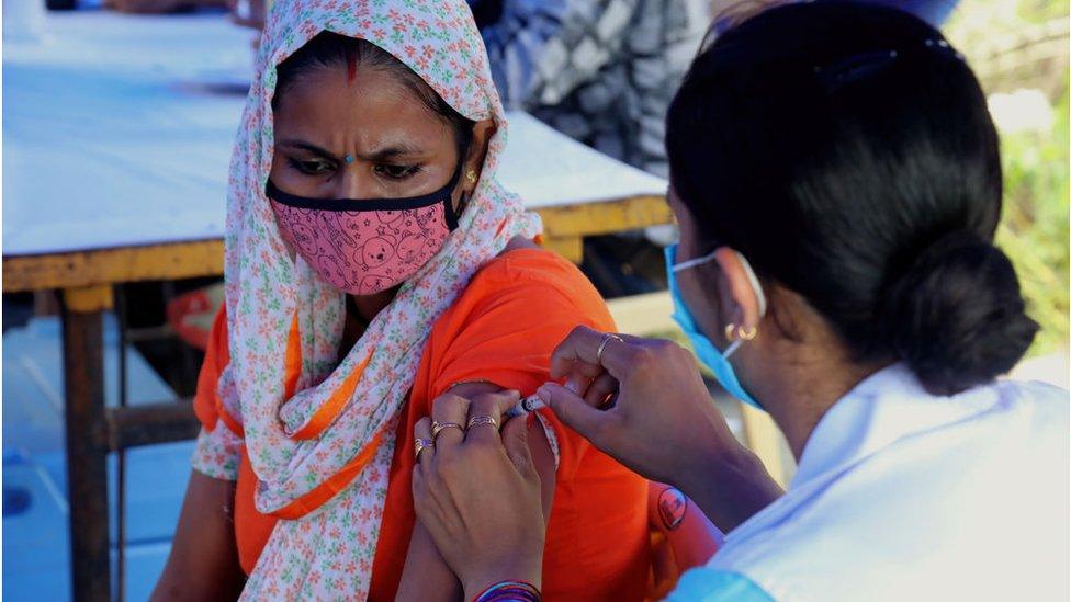 A woman being vaccinated in India