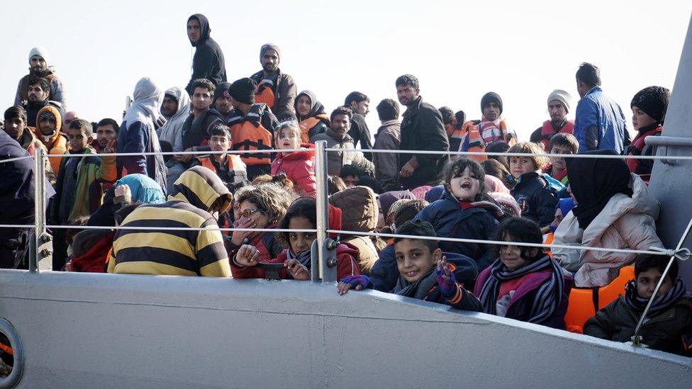 Refugees arrive aboard a Greek coast guard boat on Greek island of Lesbos on March 29, 2016, after being rescued