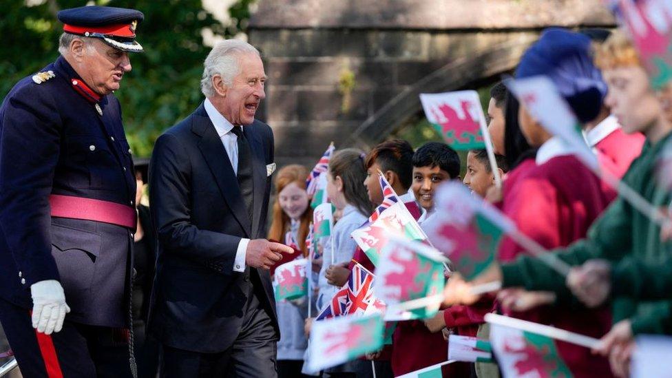 Kings Charles III laughing with children