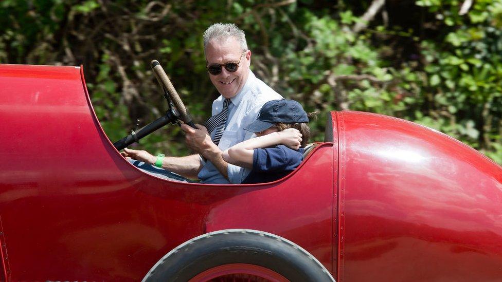 Man and boy passenger, in his 1911 Fiat S76, at Brooklands Racing Circuit on June 17, 2017 in Weybridge, England.