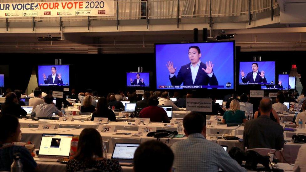 Journalists watch Yang during the Houston Democratic debate