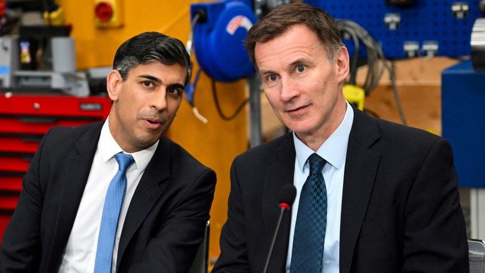 Britain's Prime Minister Rishi Sunak and Chancellor of the Exchequer Jeremy Hunt sat side by side during an event at a factory