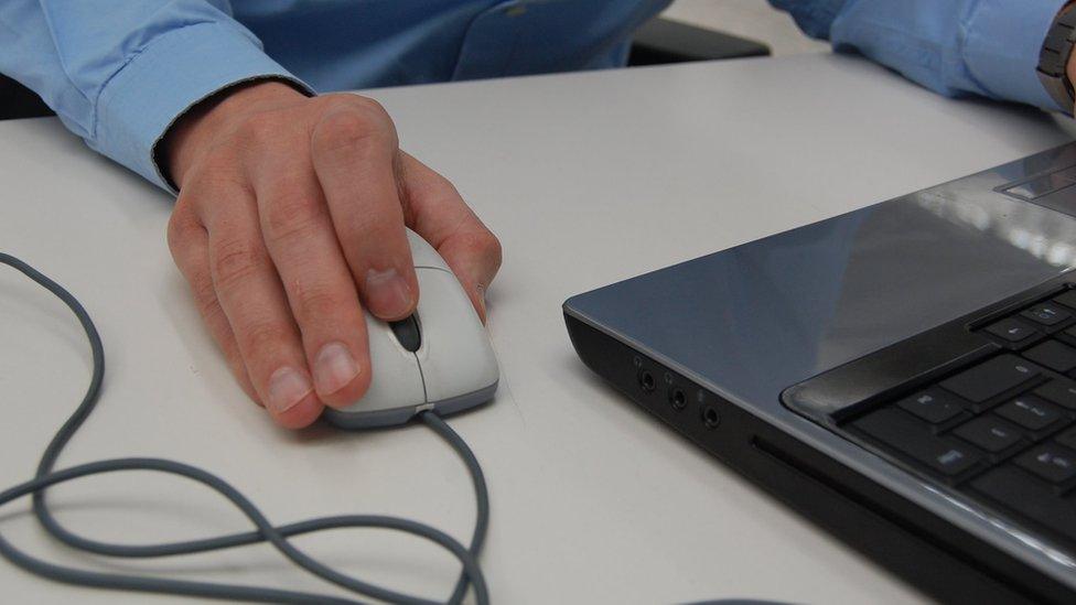 man using computer mouse and keyboard