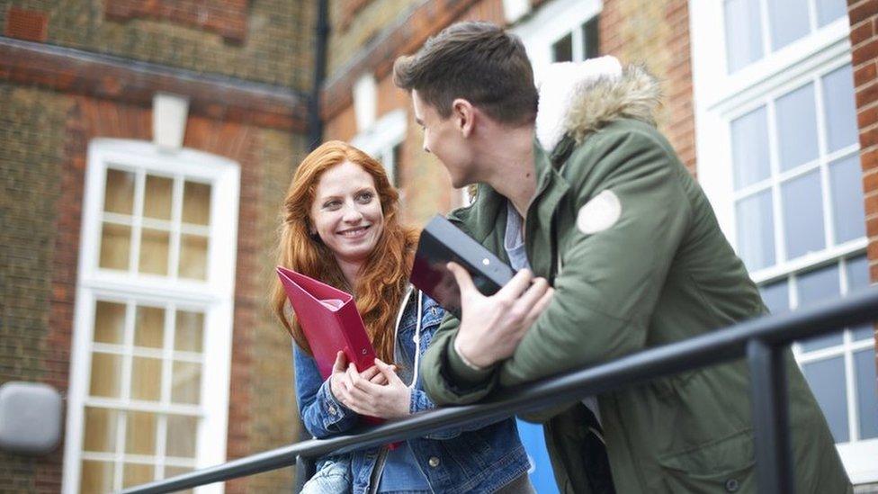 Students talking outside a university building